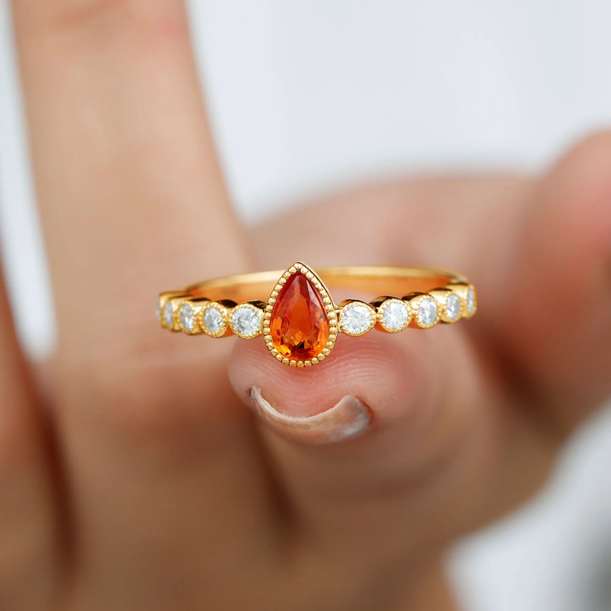 Beaded Bezel Set Pear Cut Orange Sapphire Ring with Diamond