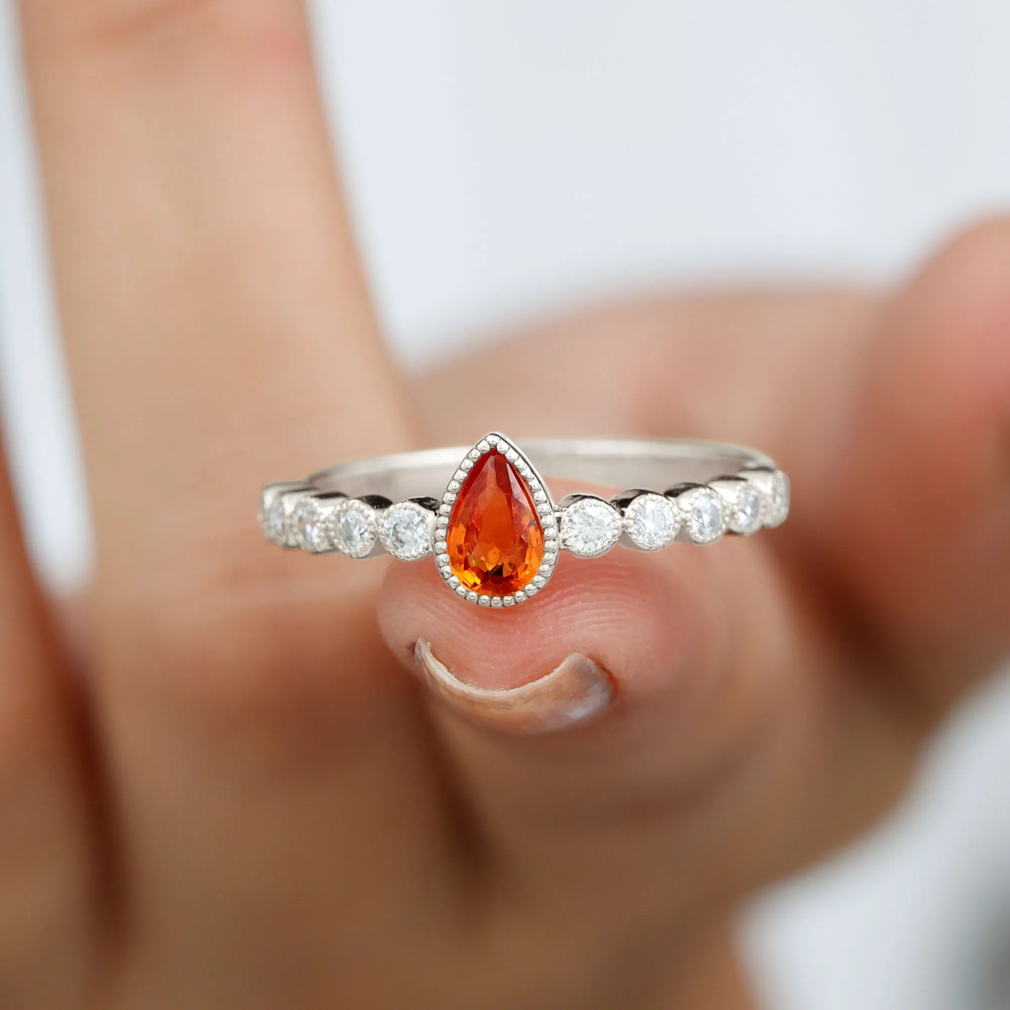 Beaded Bezel Set Pear Cut Orange Sapphire Ring with Diamond